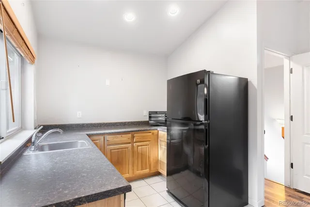 a kitchen with a refrigerator and a sink
