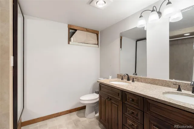 a bathroom with a double vanity sink and a mirror