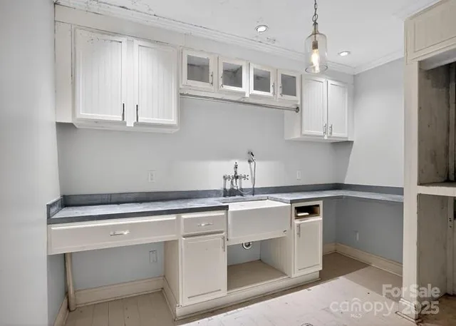 a kitchen with white cabinets and white appliances