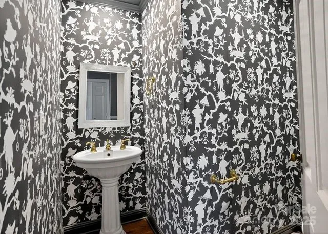 a bathroom with a sink toilet and mirror