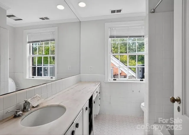 a bathroom with a sink and a window
