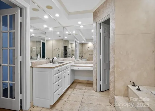a large bathroom with a double vanity sink a mirror and a shower
