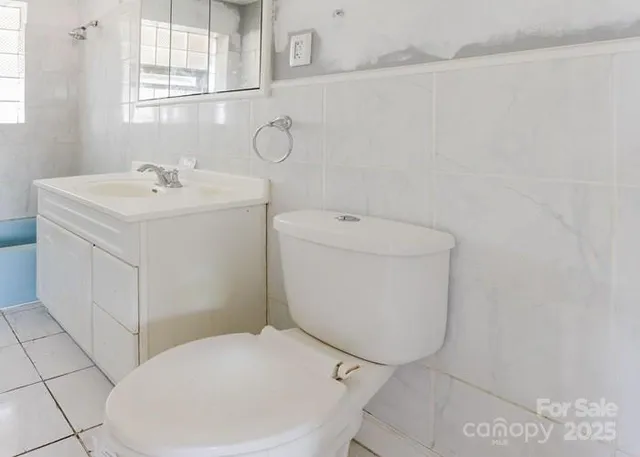 a bathroom with a sink a toilet and mirror