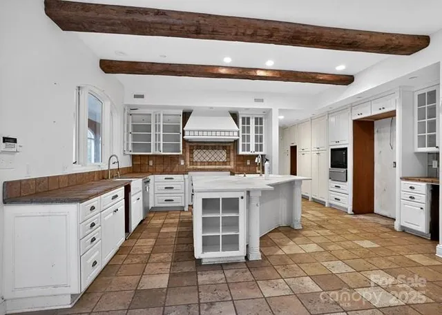 a large kitchen with stainless steel appliances granite countertop a stove and a sink