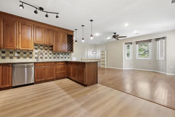 a kitchen with a sink cabinets and wooden floor