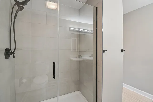 a bathroom with a glass shower door