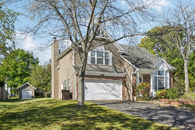 a house that has a tree in front of it