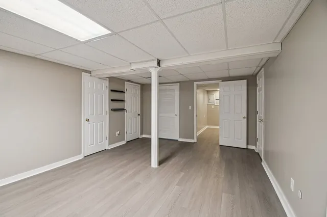 a view of an empty room with wooden floor