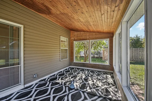a view of a room with wooden floor and windows