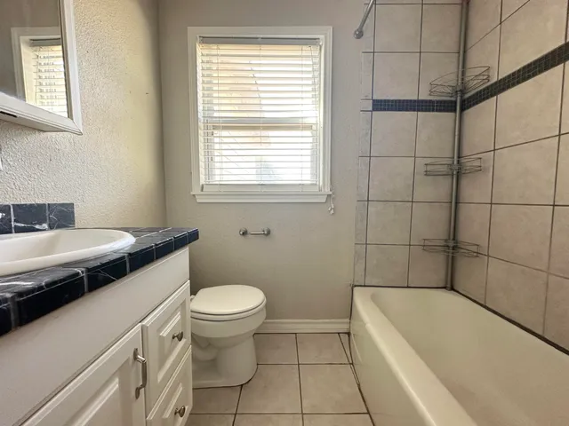 a bathroom with a sink a toilet and bathtub