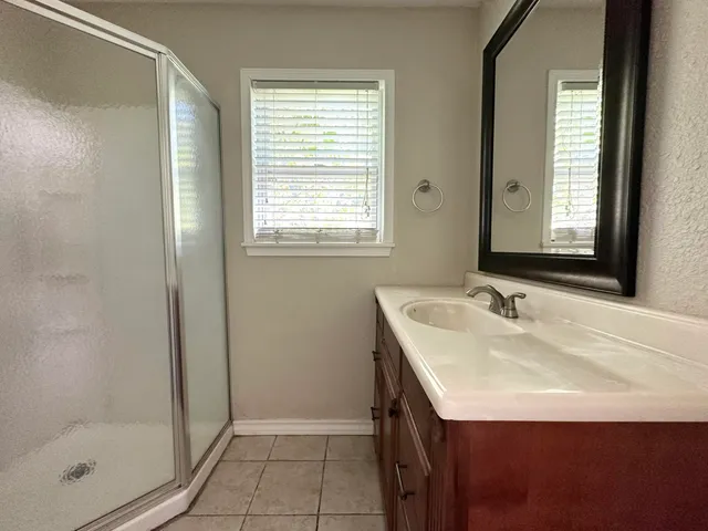 a bathroom with a sink a vanity and a mirror