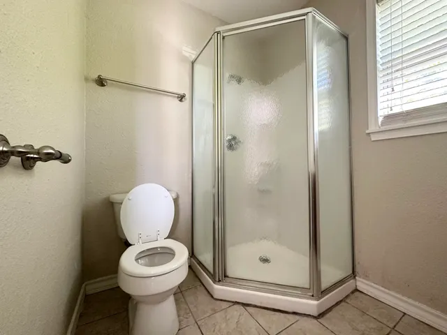 a bathroom with a shower a toilet and a sink