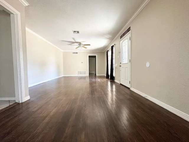 a view of a hallway with wooden floor