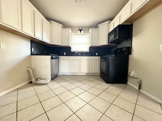 a kitchen with stainless steel appliances cabinets and a counter top space