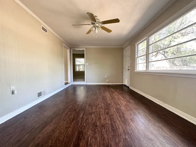 wooden floor in an empty room with a window