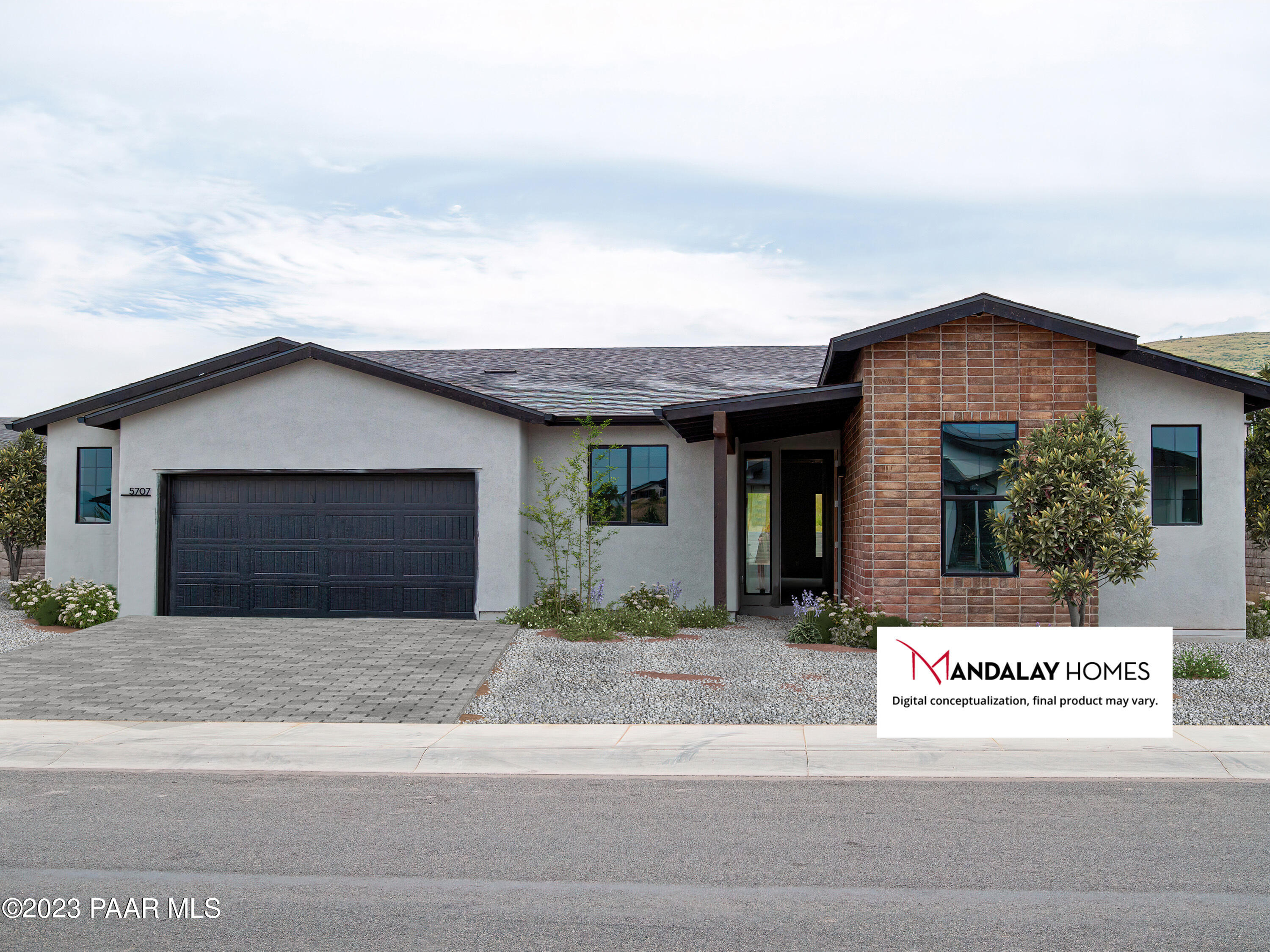 a front view of a house with a garden and garage