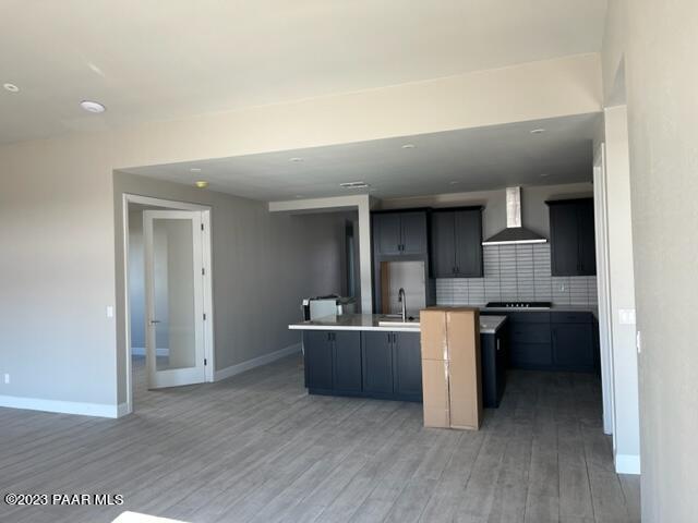 5707 East Killen Loop Prescott Valley, AZ 86314 - Photo 19 of 28 a kitchen with kitchen island a stove a refrigerator and a sink