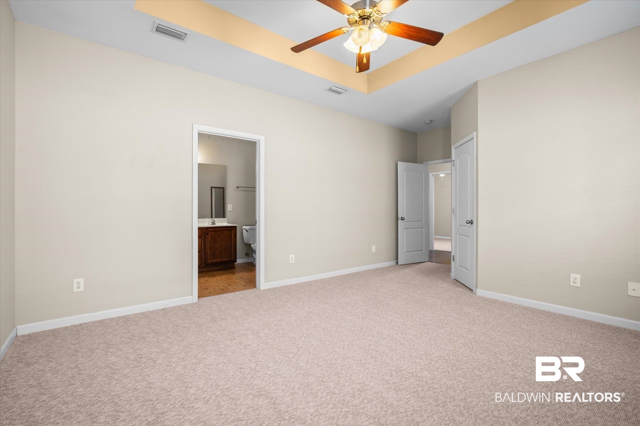 10251 Fionn Loop Daphne, AL 36526 - Photo 10 of 28 Unfurnished bedroom with ensuite bathroom, ceiling fan, and light carpet