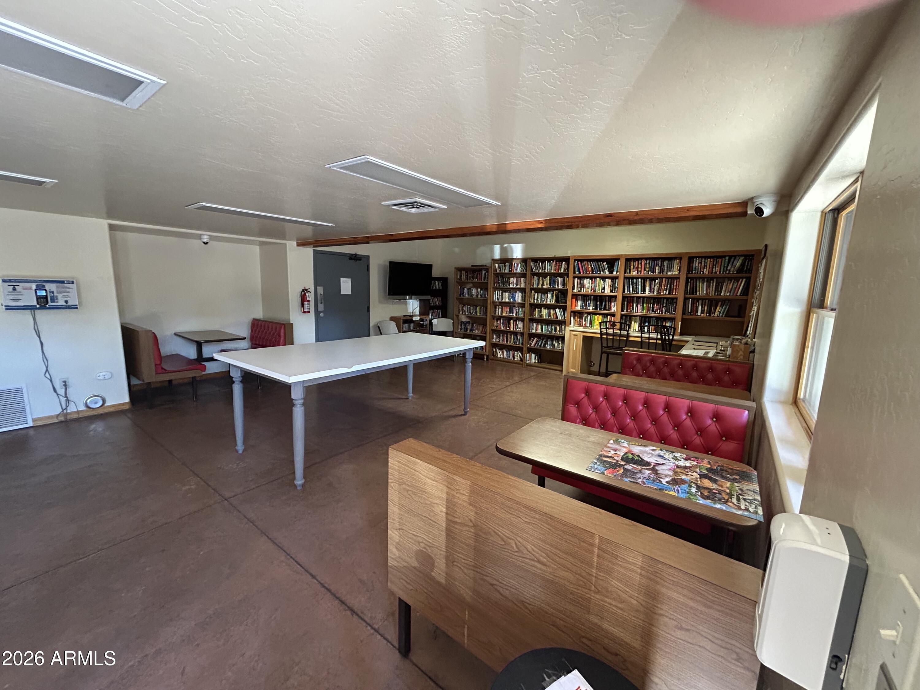 4020 South Elk Trot Loop Show Low, AZ 85901 - Photo 32 of 33 a living room with furniture a rug and white walls