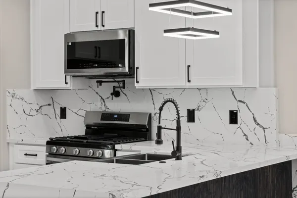 a kitchen with a stove and a white cabinets