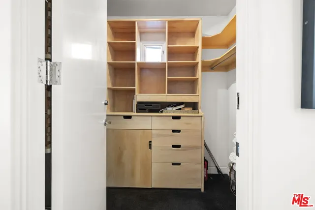 a view of walk in closet with empty racks