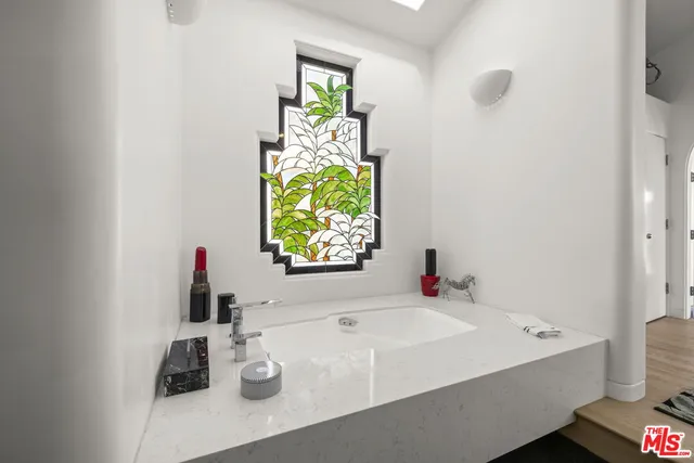 a bathroom with a sink mirror and vanity