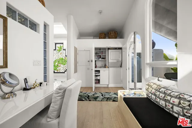 a living room with furniture windows and a potted plant