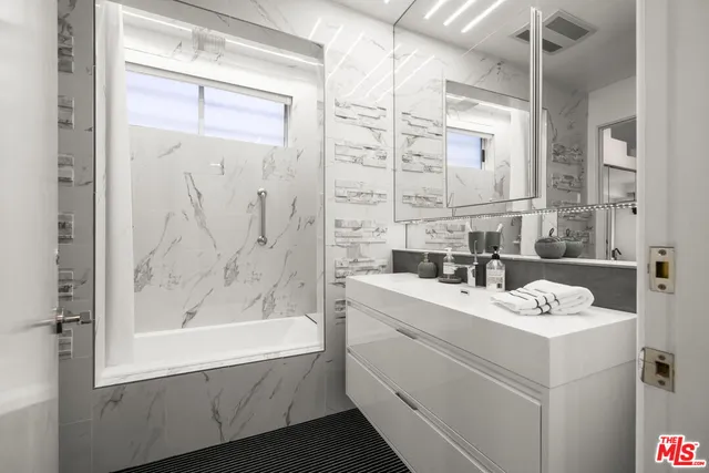 a living room with furniture a window and gym equipment