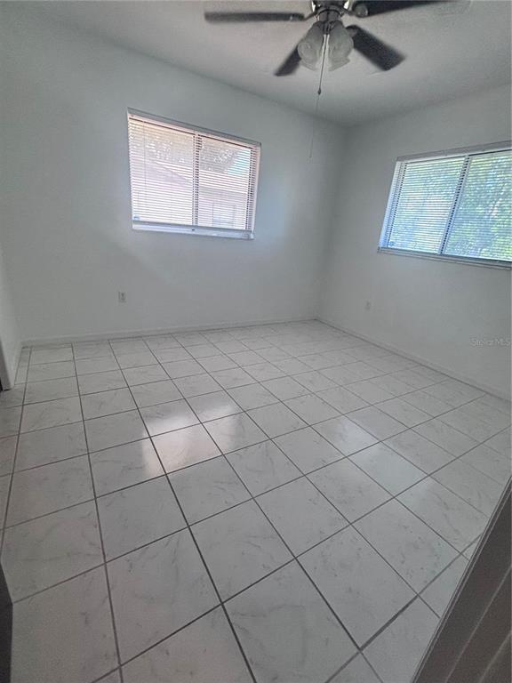 11806 Southeast 72nd Terrace Road Belleview, FL 34420 - Photo 7 of 13 an empty room with windows