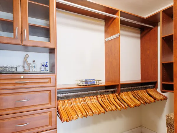 a hallway with a bed and a window