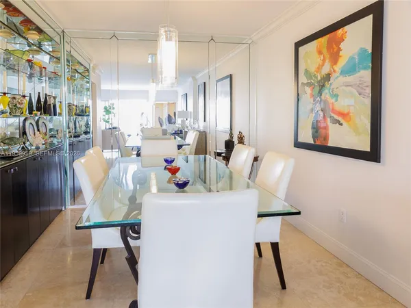 a view of a dining room with furniture and a painting