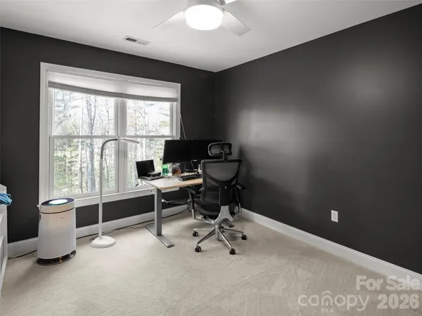 a living room with furniture gym equipment and a fireplace
