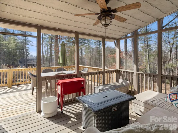 a view of a chairs and table in the back yard of the house