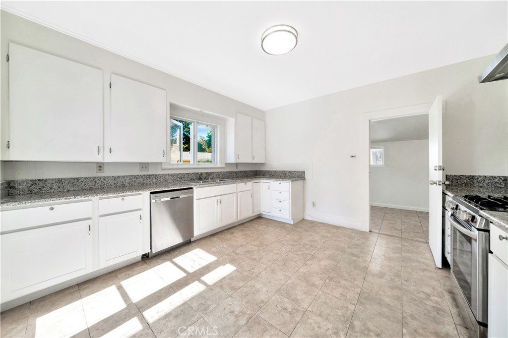 339 South Orange Street Orange, CA 92866 - Photo 21 of 52 a kitchen with granite countertop a sink a stove and cabinets