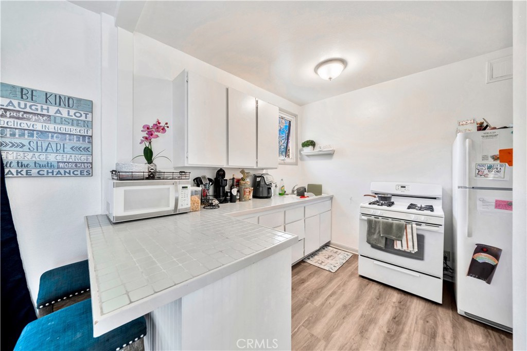 339 South Orange Street Orange, CA 92866 - Photo 34 of 52 a kitchen with granite countertop a white stove top oven and sink