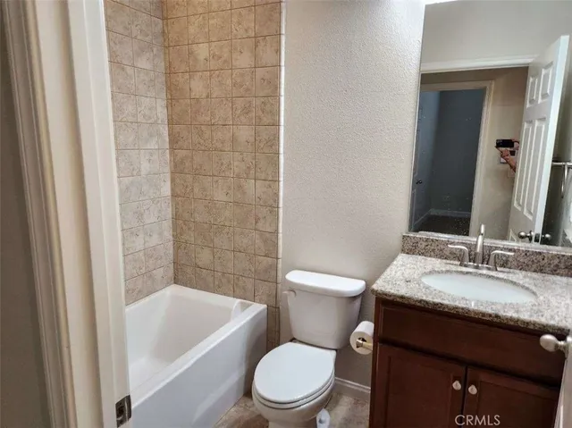 a white toilet sitting next to a bathroom sink