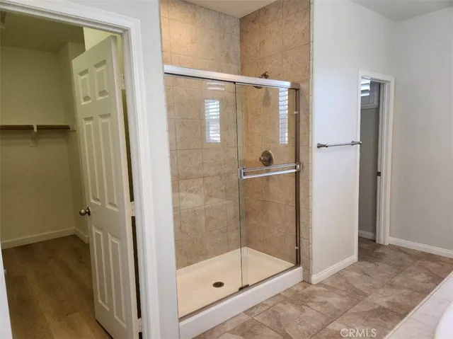 a bathroom with a glass shower door