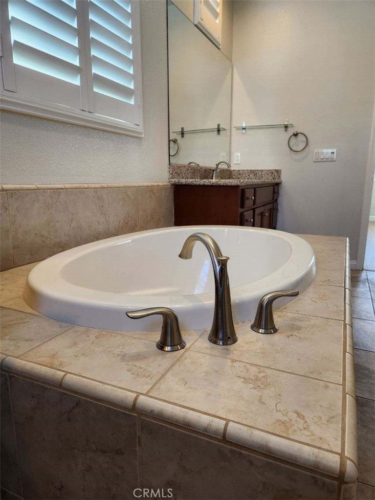 146 Violet Bloom Irvine, CA 92618 - Photo 24 of 25 a bath tub sitting in a bathroom next to a window