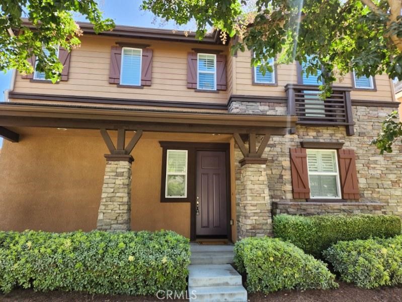 146 Violet Bloom Irvine, CA 92618 - Photo 3 of 25 a front view of a house with a yard