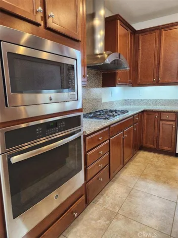a kitchen with granite countertop a stove and a sink