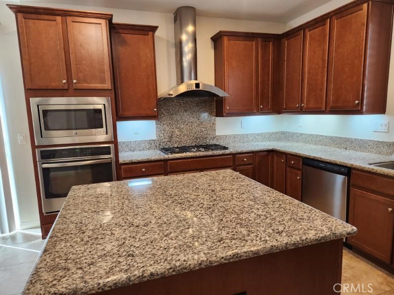 146 Violet Bloom Irvine, CA 92618 - Photo 6 of 25 a kitchen with wooden cabinets and a sink