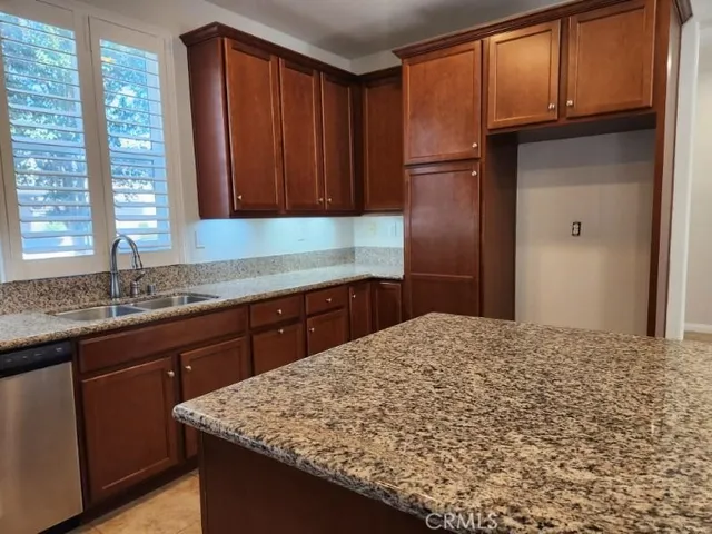 a kitchen with a sink a refrigerator and window