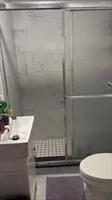 a bathroom with a glass door shower