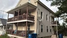 a view of a house with brick walls