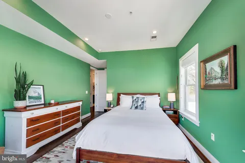 a bedroom with a bed and windows