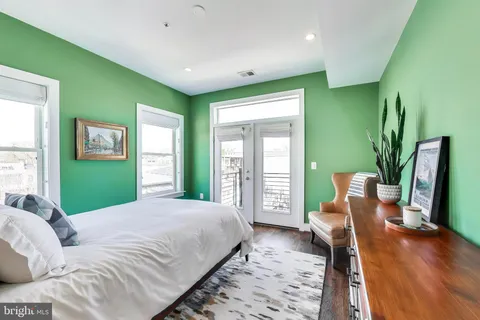 a large bedroom with a large bed and a potted plant