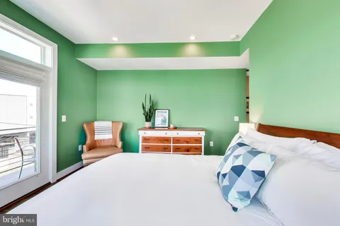 a bedroom with a bed and windows