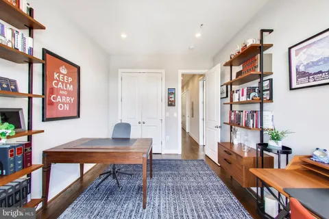 a work room with furniture and a book shelf