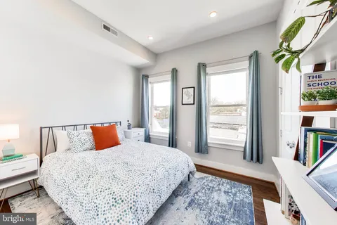 a bedroom with furniture and a rug