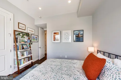 a bedroom with a bed and a book shelf